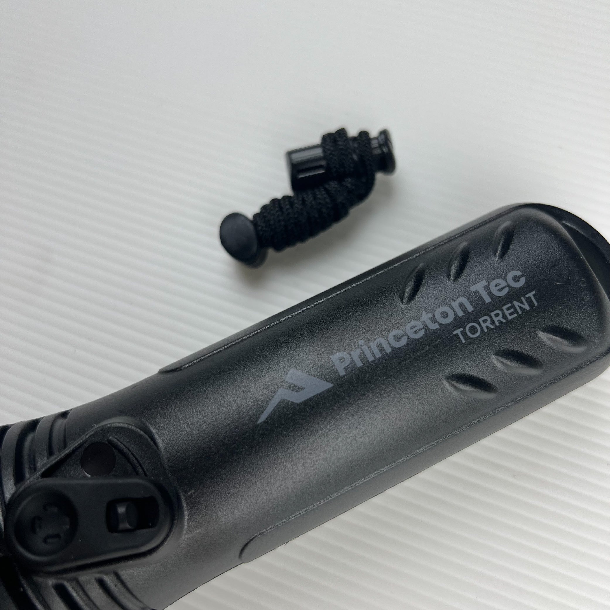 Princeton Tec Torrent Tactical Flashlight Close-Up with Lanyard - Durable Body Construction Detail