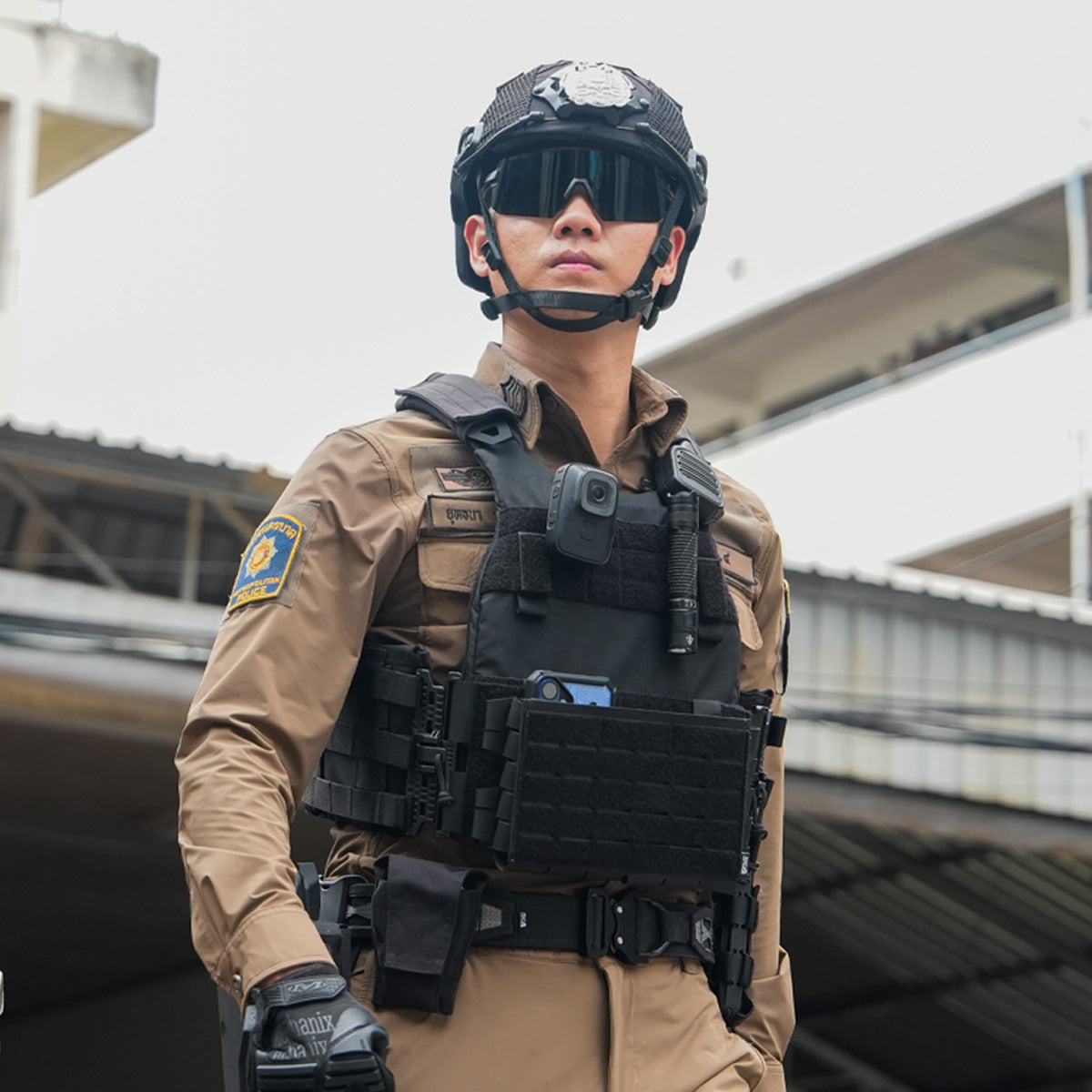 Thai Metropolitan Police Officer Standing in Full Tactical Kit with Body Camera and Plate Carrier