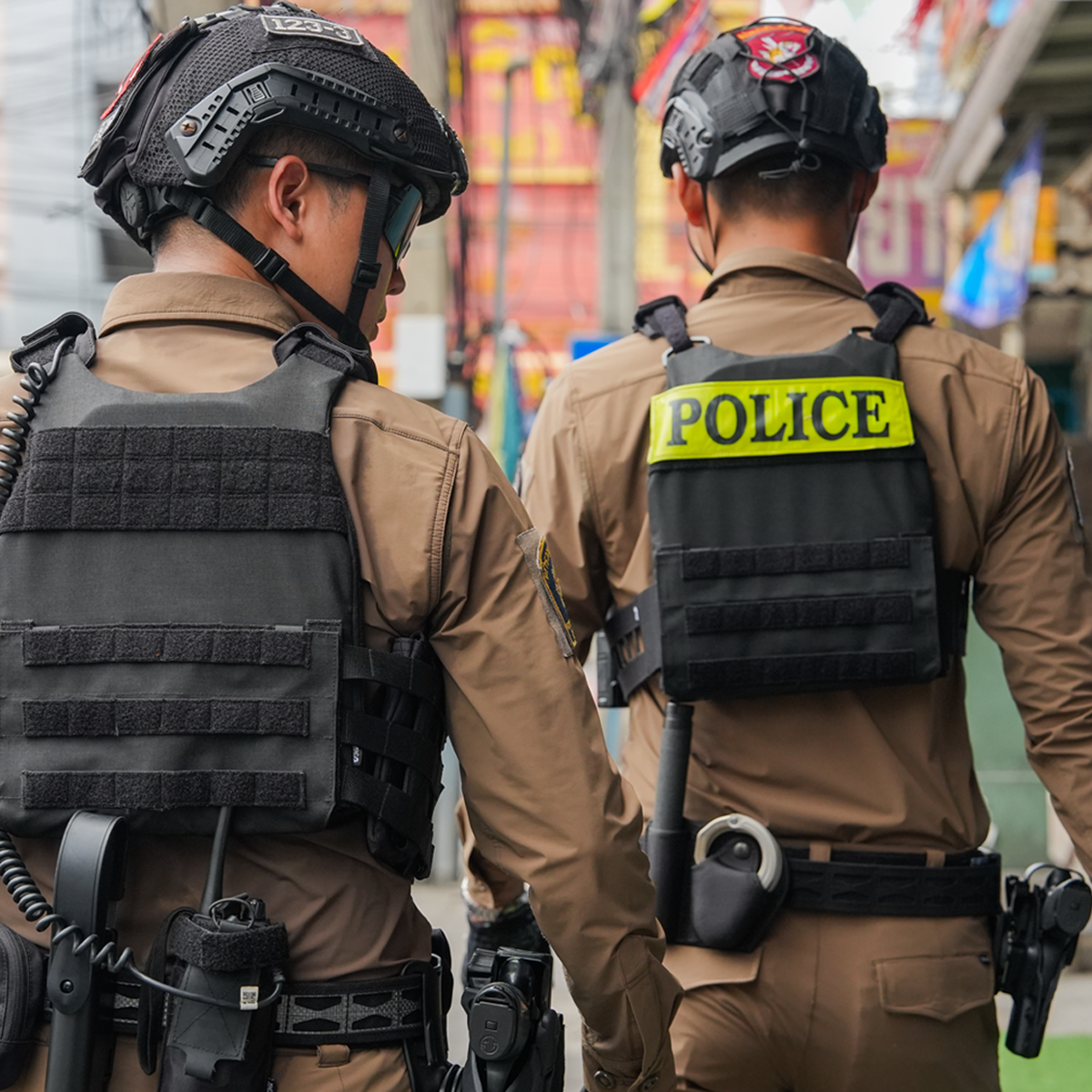 Two Thai Police Officers Rear View in Tactical Plate Carriers with POLICE Identifier - Full Duty Gear